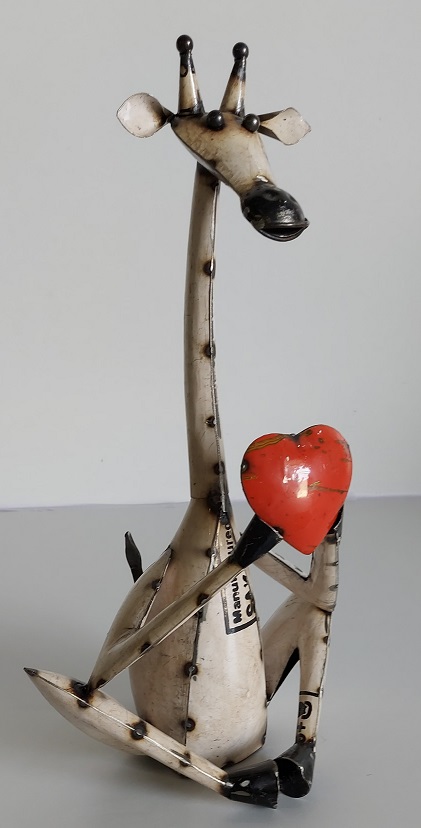 Zittende giraf met hart van gerecycled blik